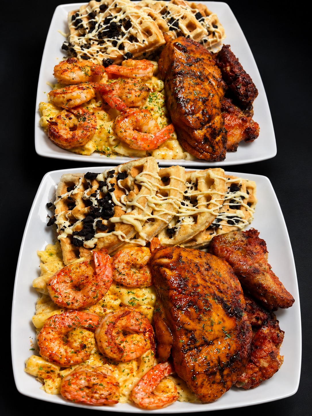 Two Trap Queen House boxes: Oreo waffles, prawns on mac and cheese, glazed chicken and wings